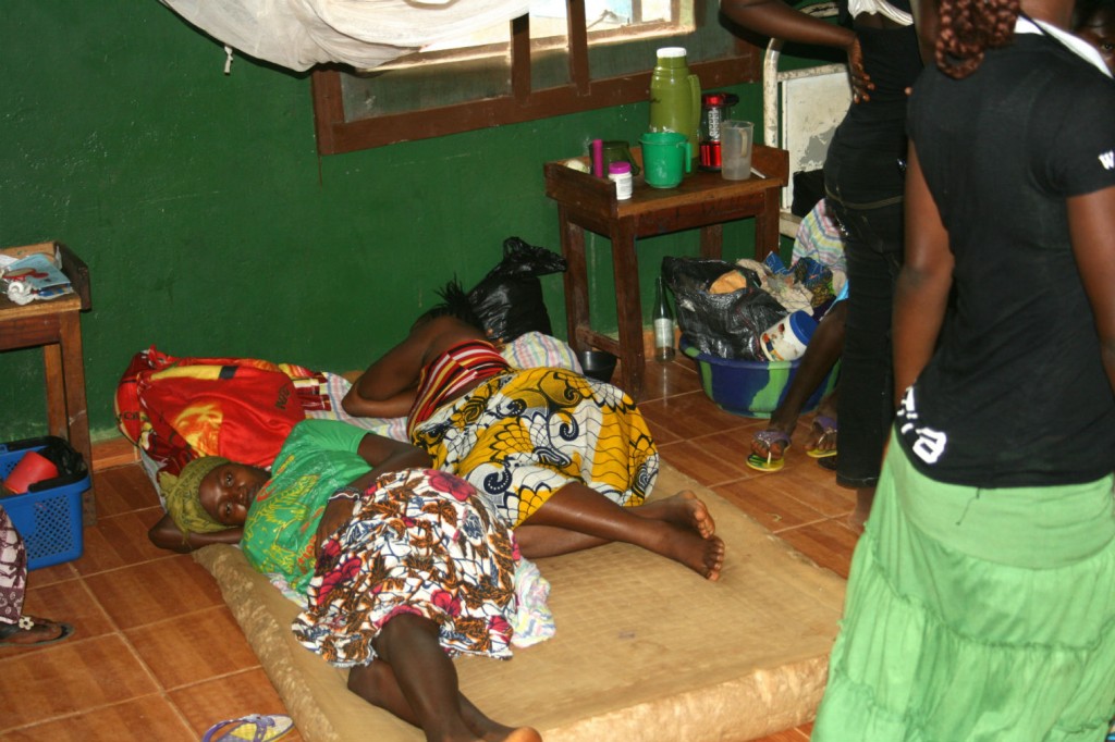 Women labouring on the floor.